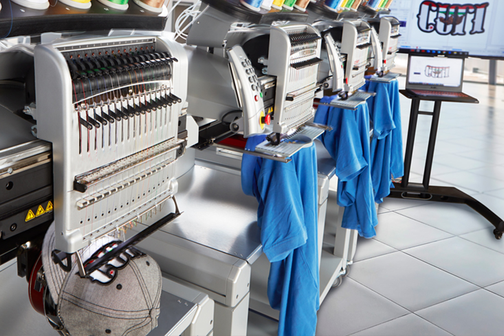 Embroidery machine and sport cap close up picture Embroidery machine and sport cap close up picture
